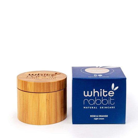 Wooden jar and blue box of White Rabbit Natural Skincare on a white background