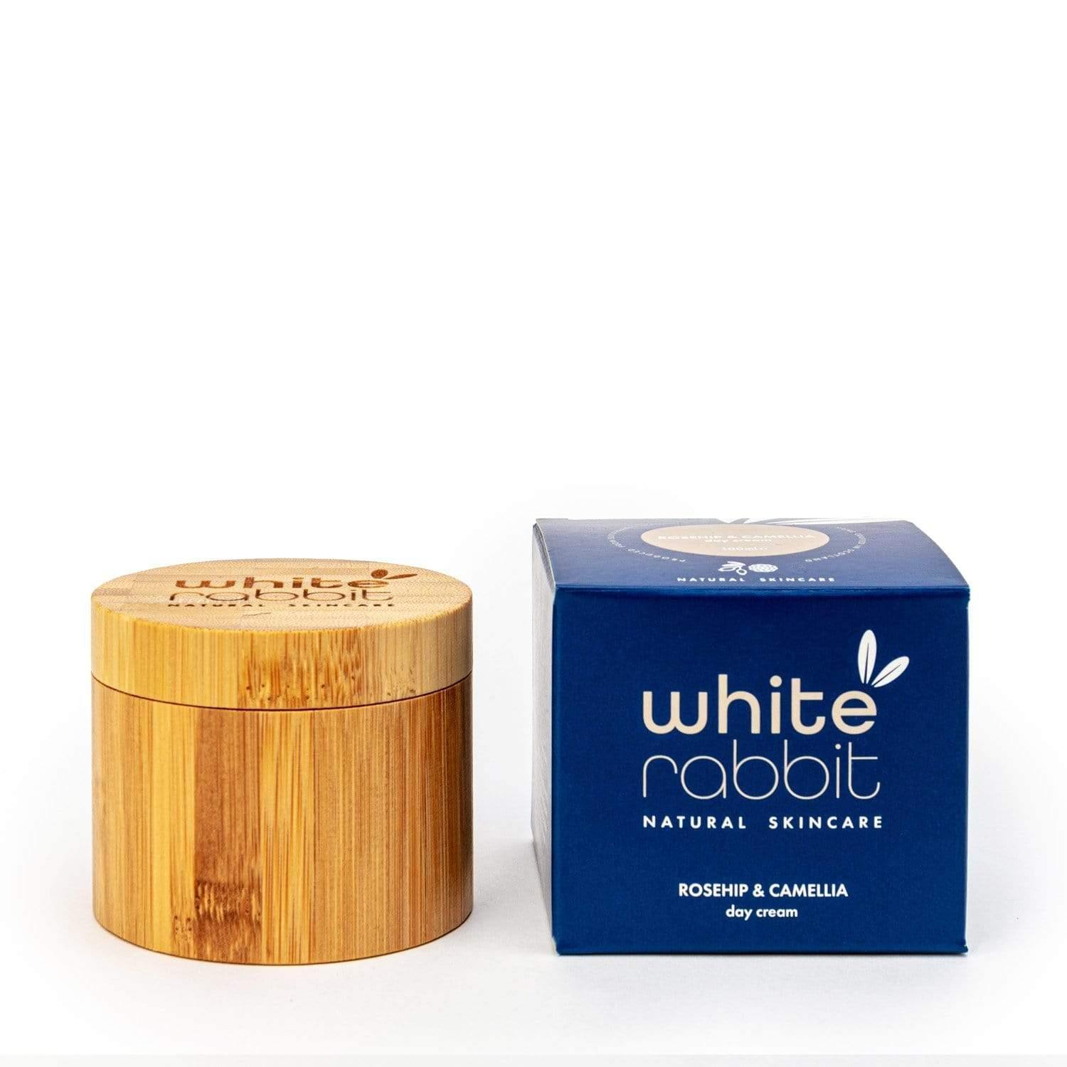 Wooden jar and blue box of White Rabbit Natural Skincare on a white background