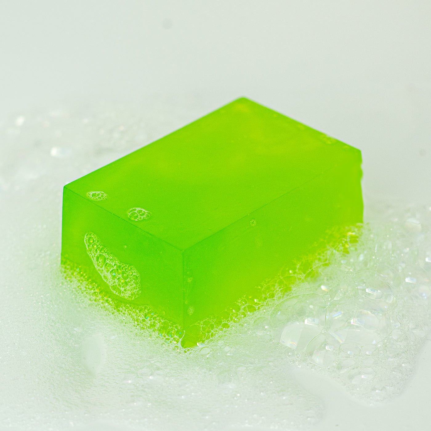 Green bar of soap on a white background