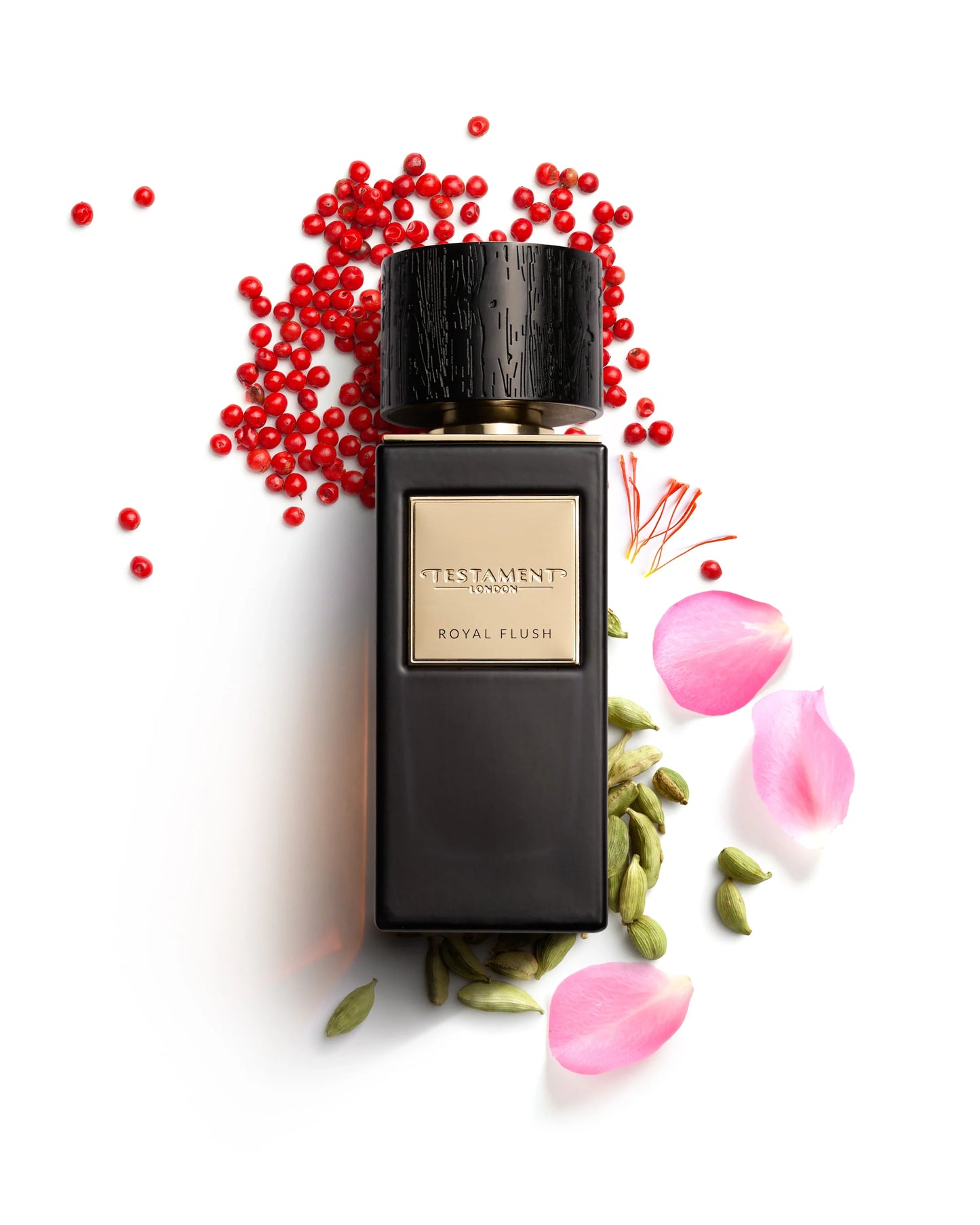 Perfume bottle labeled 'Testament' with red berries and pink petals on a white background