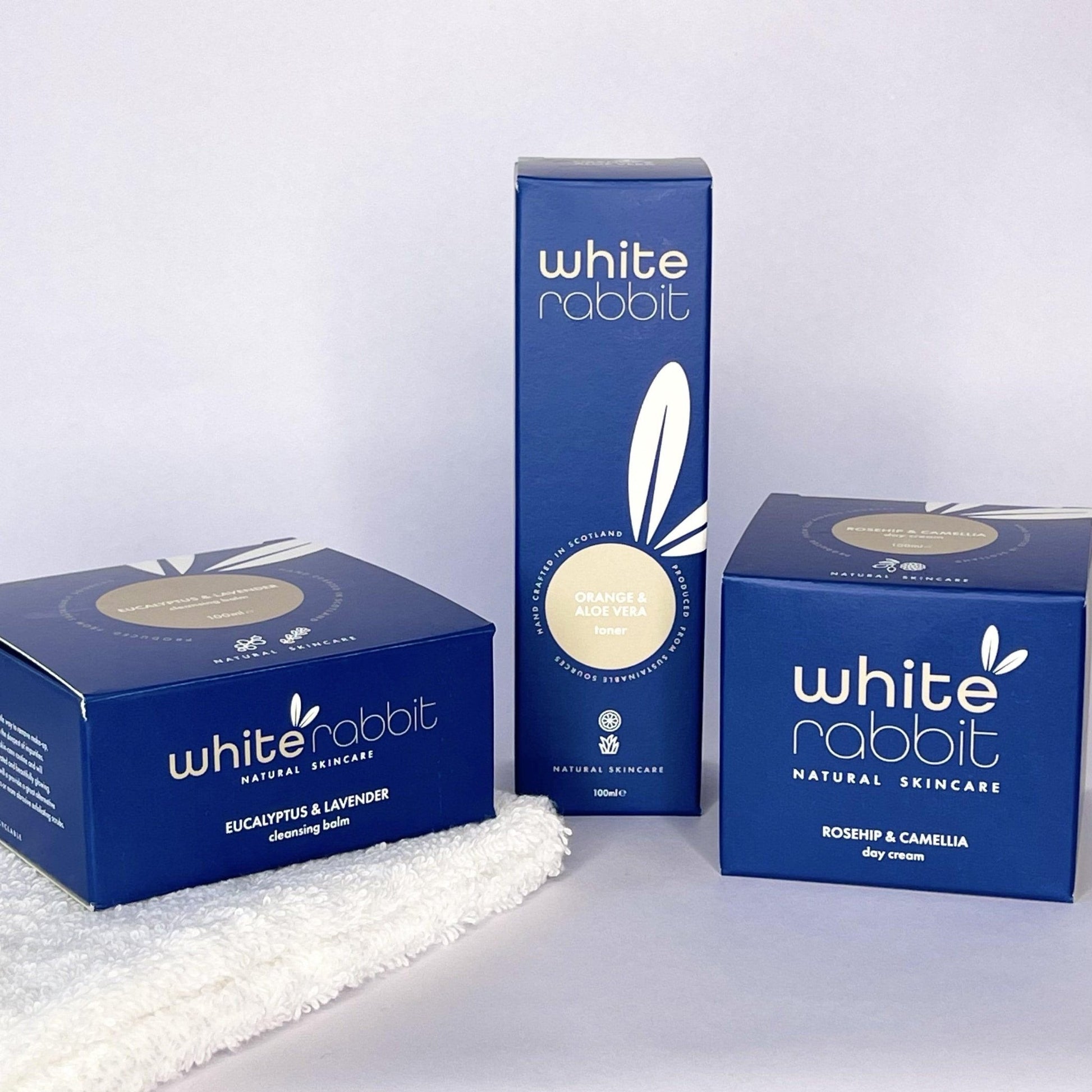 Three 'White Rabbit' skincare product boxes on a white background