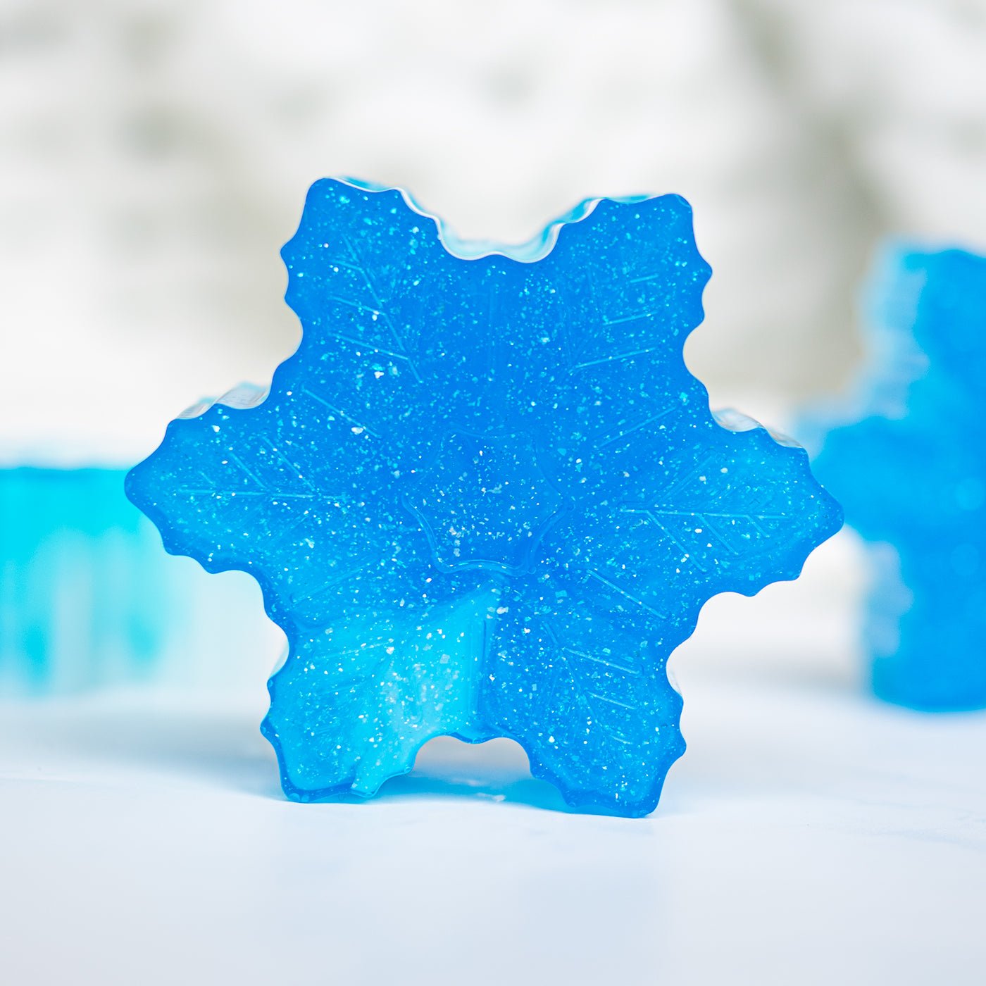 Blue leaf-shaped soap with a textured surface on a white background