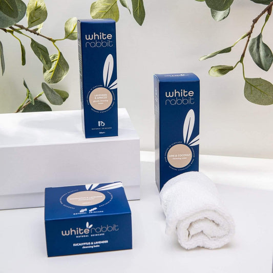 White Rabbit product packaging on a white surface with green leaves in the background