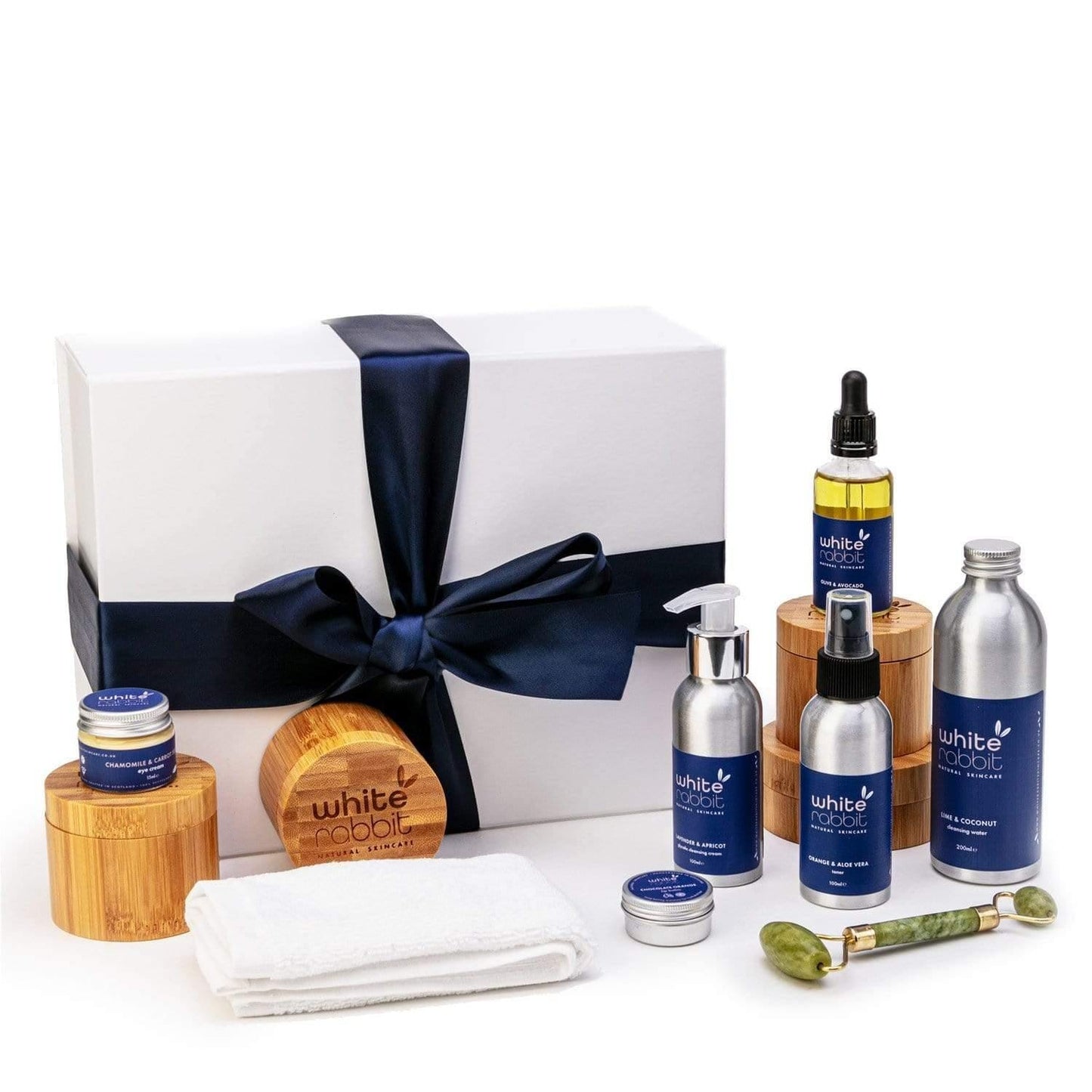 White Rabbit skincare product set with bottles, jars, and a box on a white background