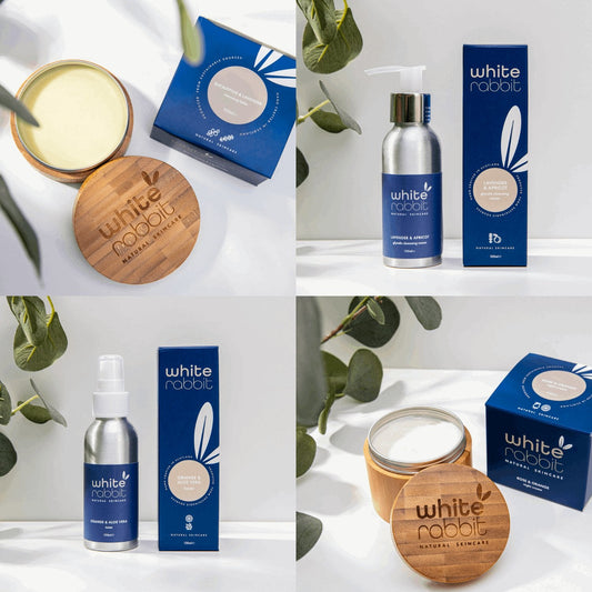 White Rabbit skincare products including a bottle, box, and jar on a white background with green leaves.